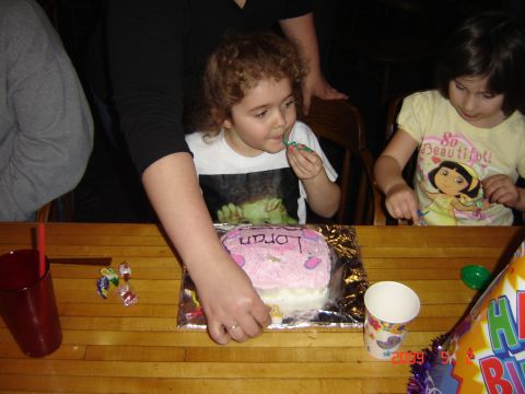 1993 Ford Bronco - A birthday celebration is underway with a decorated cake and party hats on the table.
