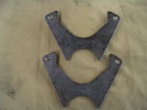 1995 Ford Bronco - Two custom metal brackets are shown against a light brown background.