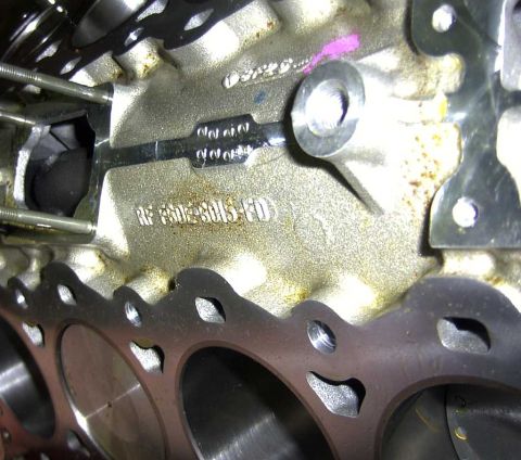 1997 Ford Taurus - A close-up view of an engine block reveals various casting numbers and markings.