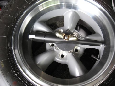 1968 Shelby GT500 - A silver five-spoke wheel with a tire and lug nut tool is shown in detail.