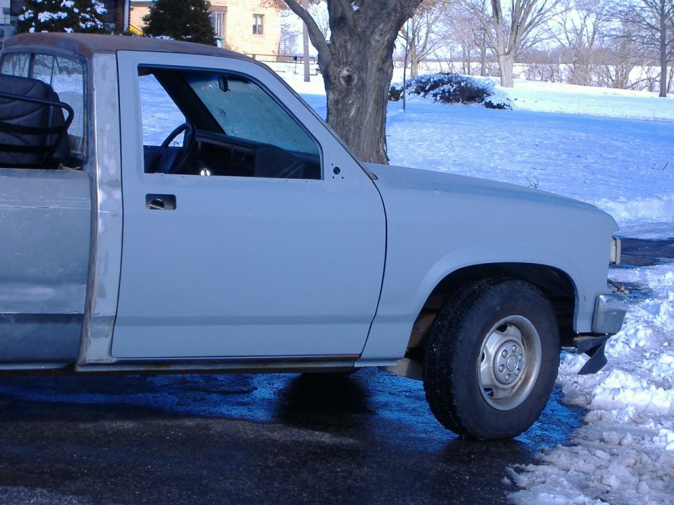 1992 Dodge Dakota truck cab and fender, primer gray, in snowy outdoor setting