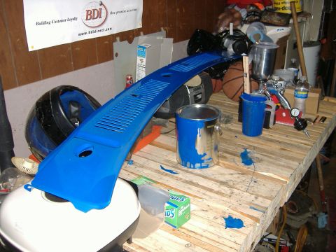 1992 Dodge Dakota - A blue painted car part sits on a workbench next to paint supplies.