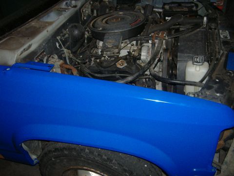 1992 Dodge Dakota - The engine bay of a vehicle with a freshly painted blue fender is visible.