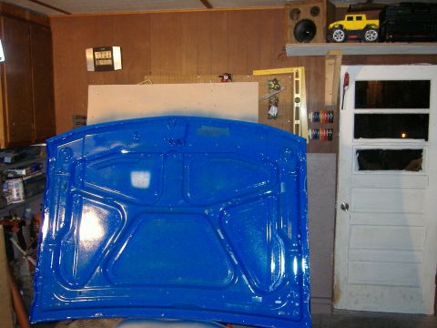 1992 Dodge Dakota - The underside of a car hood, painted a vibrant blue, is shown in a garage setting.