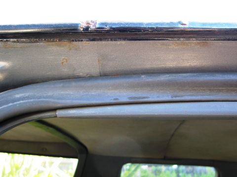 1986 Ford Bronco - The interior roofline shows signs of wear and rust, indicating age and exposure.