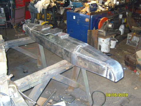1989 Ford Bronco - A custom-built steel bumper is displayed on sawhorses in a workshop environment.