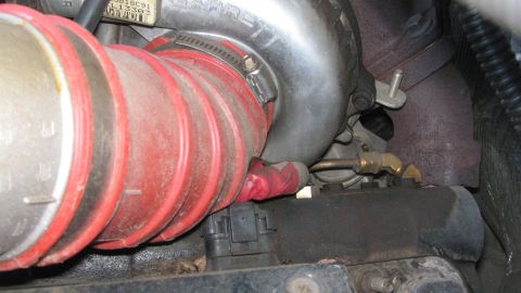 1996 Ford C-350 (Centurion Conversions) - Close-up view of engine components, including a turbocharger and red intake pipe.