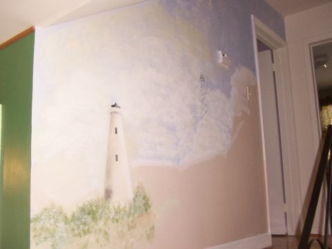 1998 Ford Taurus - A mural depicts a lighthouse and grassy cliff, with a green door and a doorway visible in the room.