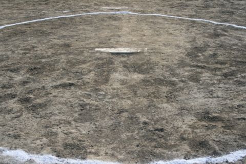 1990 Chevrolet Suburban - A view of a baseball field, showing the dirt infield and white foul lines.