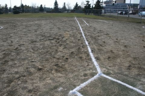1990 Chevrolet Suburban - A baseball field is shown with chalk lines marking the bases and foul lines.