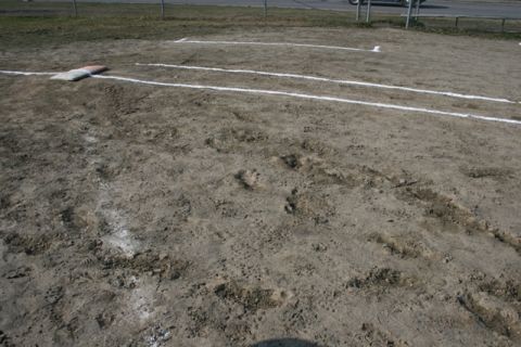 1990 Chevrolet Suburban - A baseball field is shown with bases and lines marked on the dirt, along with evidence of vehicle tracks.