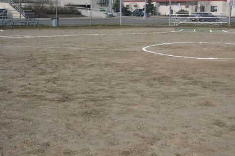 1990 Chevrolet Suburban - A view of a softball field, showing the dirt infield and base paths.