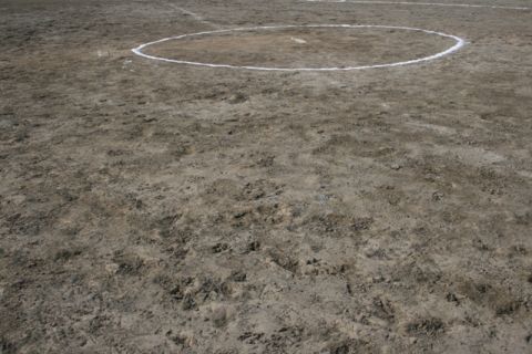1990 Chevrolet Suburban - A view of a softball field, showing the dirt infield and the chalked circle around home plate.