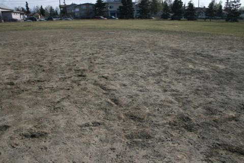 1990 Chevrolet Suburban - A baseball field's infield is shown with a base visible in the distance.