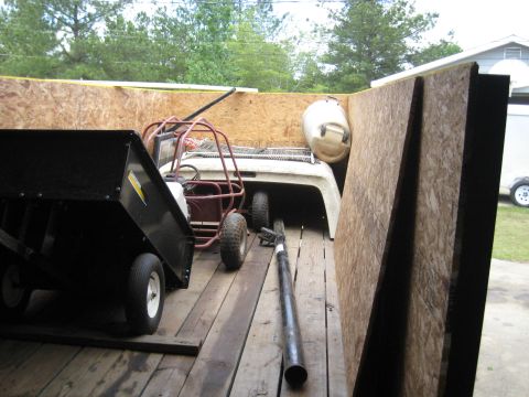 1900 Ford C-350 (Centurion Conversions) - A golf cart and a black trailer are loaded into a larger trailer.