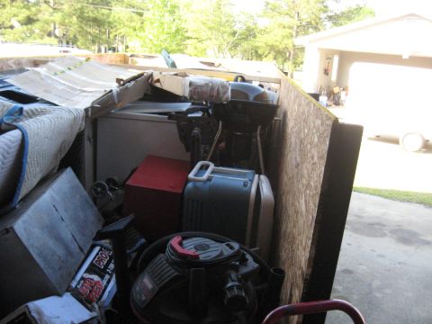1900 Ford C-350 (Centurion Conversions) - A dumpster is filled with various items, suggesting a clean-out or moving process.
