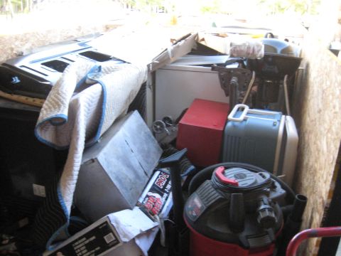 1900 Ford C-350 (Centurion Conversions) - Trailer packed with miscellaneous items, including automotive parts and appliances.