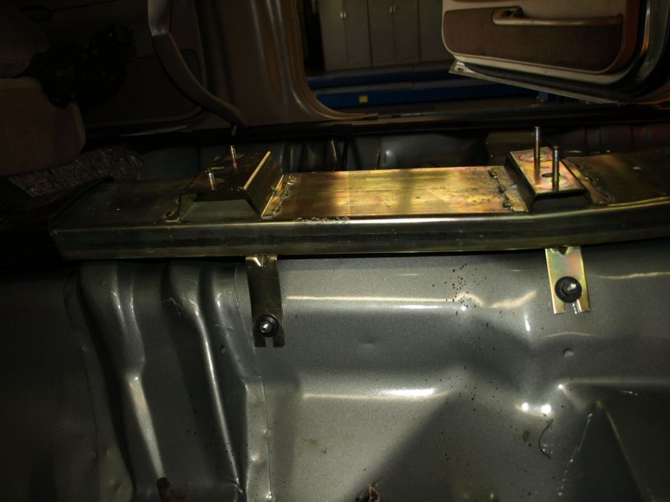 Interior view of metal bracing installed on the floor of a vehicle