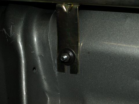 1999 Ford Crown Victoria - Detail of a metal bracket fastened with a bolt and nut.