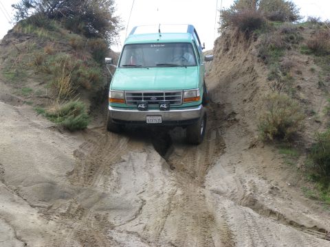1996 Ford Bronco - This 1996 Ford Bronco navigates a challenging dirt trail, its off-road capabilities.