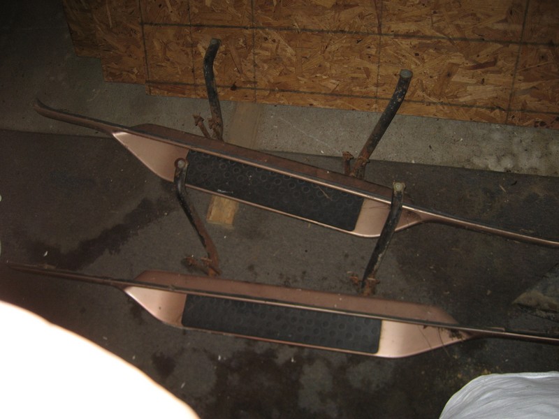 pair of running boards with black textured inserts and copper-colored trim