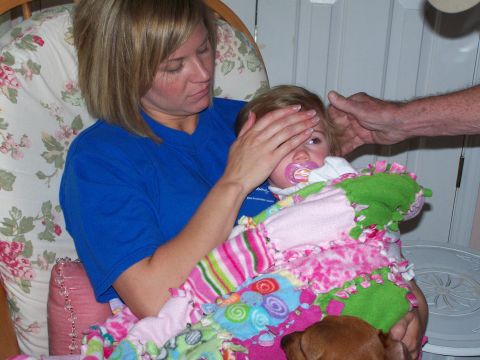 1978 Ford Bronco - A woman gently covers a baby's eyes while the child is wrapped in a colorful blanket.