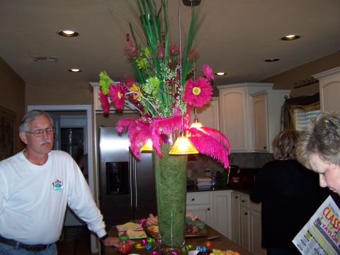 1978 Ford Bronco - Interior view of a kitchen with people and a tall vase filled with flowers and feathers.
