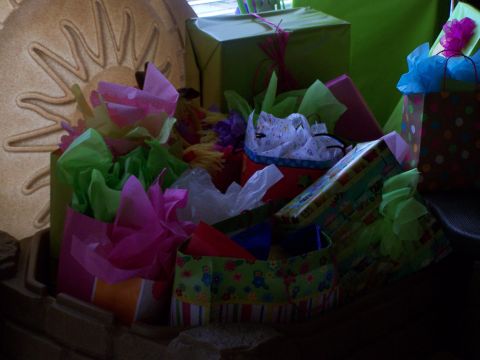 1978 Ford Bronco - A collection of gift bags and wrapped presents are arranged together, some with colorful tissue paper spilling out.