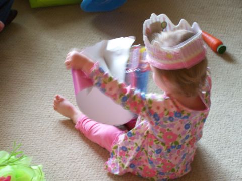 1978 Ford Bronco - Child plays with toys while wearing a princess crown and a floral dress.