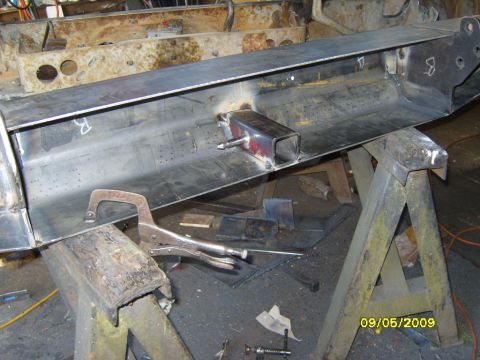 1989 Ford Bronco - A custom fabricated metal part is shown supported by sawhorses with clamps attached.