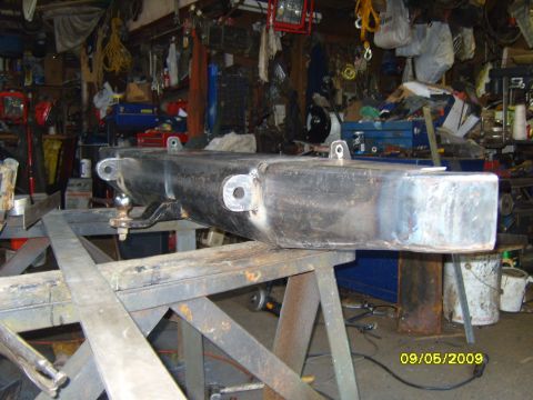 1989 Ford Bronco - A rear bumper assembly with a tow hitch is shown in a workshop setting.