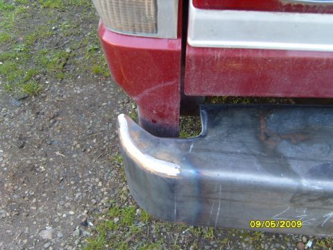 1989 Ford Bronco - Close-up of a vehicle's rear bumper corner and taillight assembly.