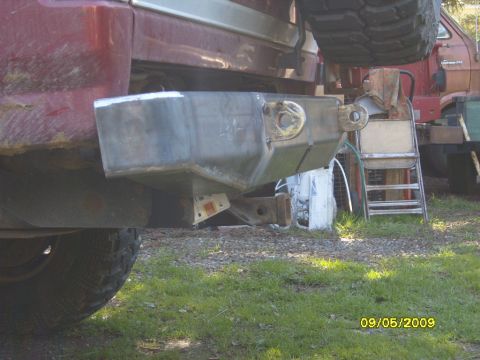 1989 Ford Bronco - A custom metal rear bumper with tow hitch is installed on a red SUV, with a spare tire mounted above.