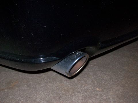 2007 Ford Mustang - Close-up of a black car's exhaust pipe, which has the brand name 'BORLA' etched into the metal tip.