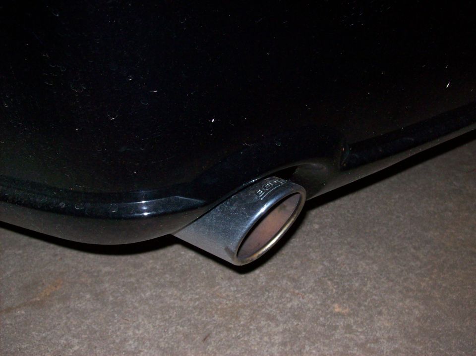 Black car exhaust pipe with 'BORLA' etched on it