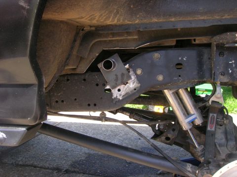 1996 Ford Bronco - Close-up view of modified rear suspension components on a vehicle.