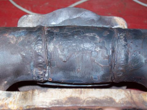 1986 Toyota Hilux - This is a close-up view of a welded metal pipe section, showing signs of wear and peeling paint.