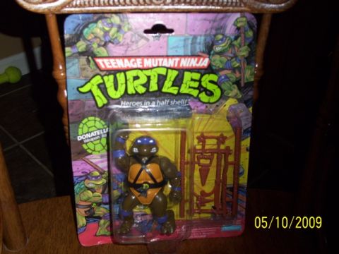 1991 Ford Bronco - A Teenage Mutant Ninja Turtles action figure is displayed in its original packaging.