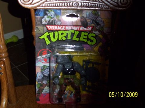 1991 Ford Bronco - Rocksteady action figure from Teenage Mutant Ninja Turtles is displayed in its original packaging.