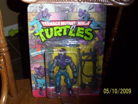 1991 Ford Bronco - A packaged Teenage Mutant Ninja Turtles Foot Soldier action figure with accessories is displayed.