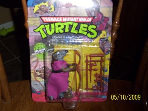 1991 Ford Bronco - Packaging for a Teenage Mutant Ninja Turtles action figure, Splinter, is displayed on a table.