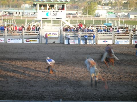 1996 Ford Bronco - A rodeo event unfolds in an arena with participants and spectators watching from the stands.