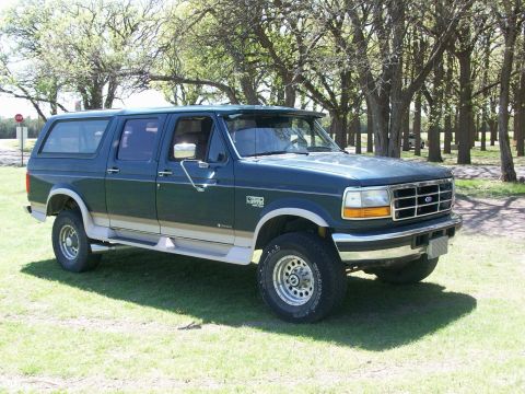 1995 Ford C-350 (Centurion Conversions) - This 1995 Ford C-350 Centurion Conversion SUV is presented in a dark green exterior with tan lower trim.