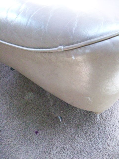 1995 Ford C-350 (Centurion Conversions) - Close-up of a worn leather seat cushion, showing signs of wear and tear.