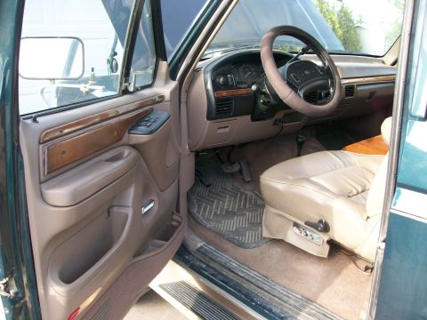 1995 Ford C-350 (Centurion Conversions) - Tan leather seats and wood-grain door panel details visible inside the truck's cabin.