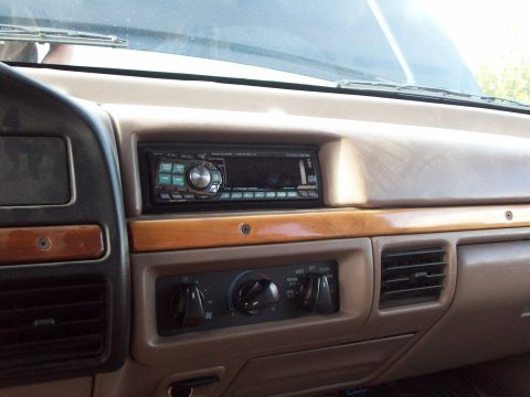 1995 Ford C-350 (Centurion Conversions) - Interior view of a vehicle's dashboard, focusing on the stereo and climate controls.