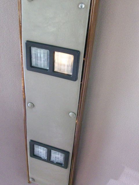 1995 Ford C-350 (Centurion Conversions) - Close-up of an interior panel showing two pairs of gauges, one of which is lit.