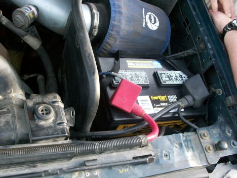 1995 Ford C-350 (Centurion Conversions) - Close-up view of a vehicle's engine bay, focusing on the battery and air intake system.