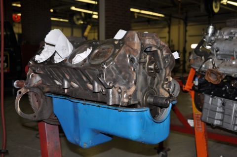 1996 Ford Bronco - Engine block and oil pan assembly on a stand, with another engine in the background.