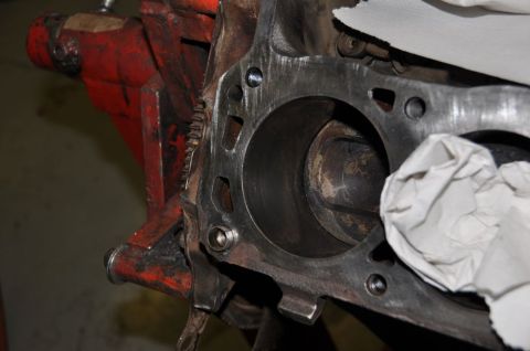 1996 Ford Bronco - A mechanic cleans out an engine block cylinder, preparing it for rebuild.